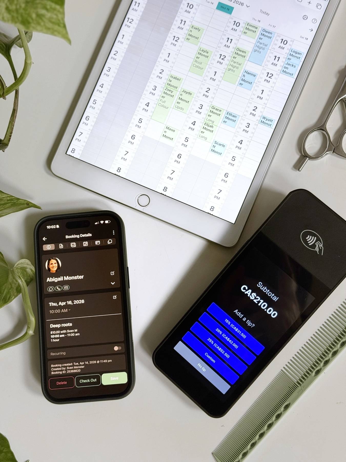 A tablet showing a salon calendar beside a phone and a card reader displaying a sale total