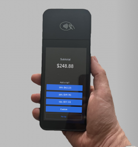 Holding a WisePOS E payment terminal